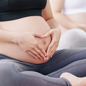 women touching stomach doing pregnancy physio exercises